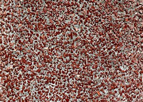 Grey grit wash wall plaster with exposed red stones