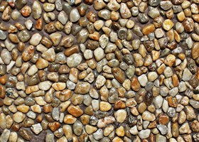 Exposed pebbles used for wall finish in brown colour base